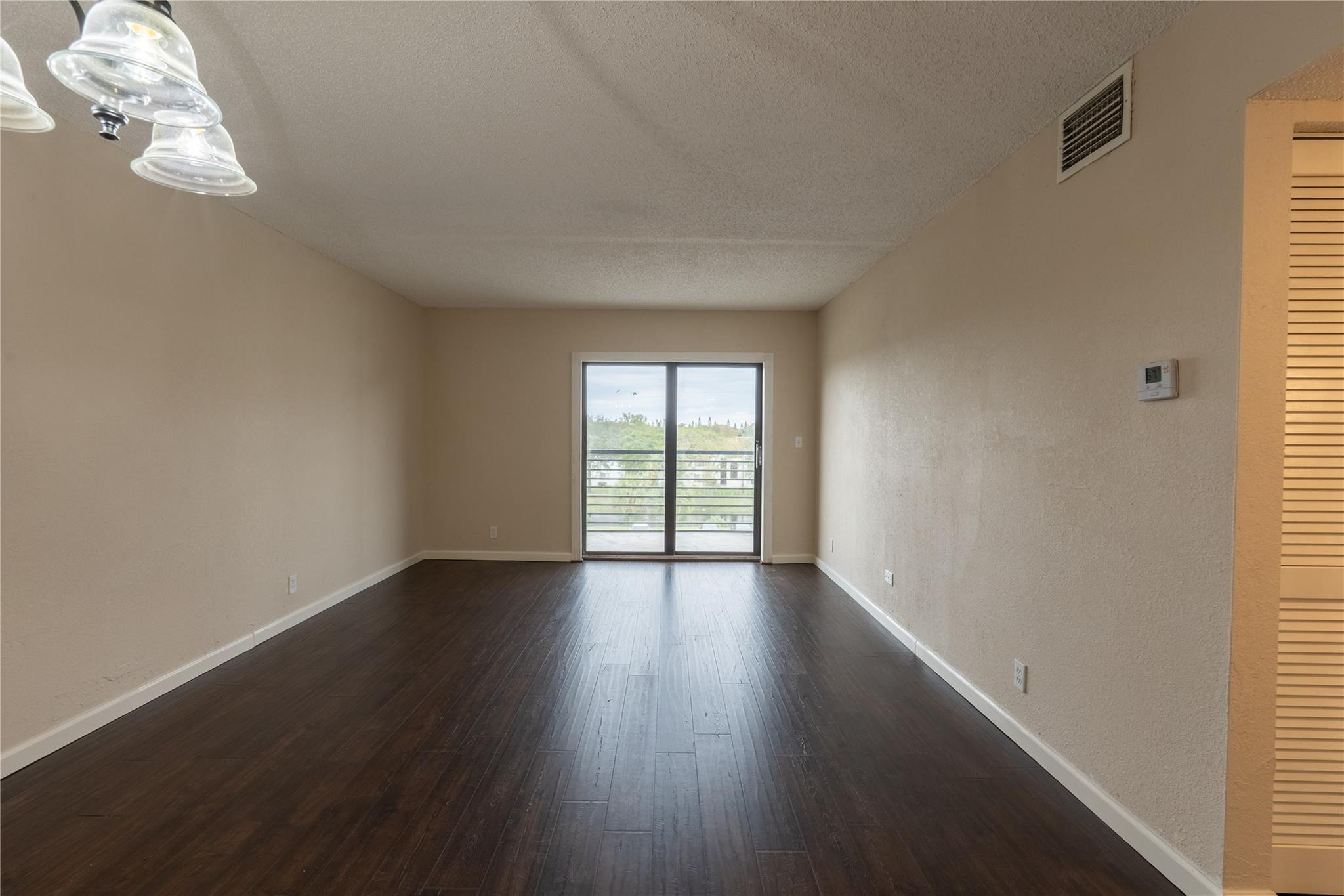 3720 North Pine Island Road, Unit 436 Sunrise, FL 33351 - Photo 13 of 26 a view of an empty room with wooden floor and a window