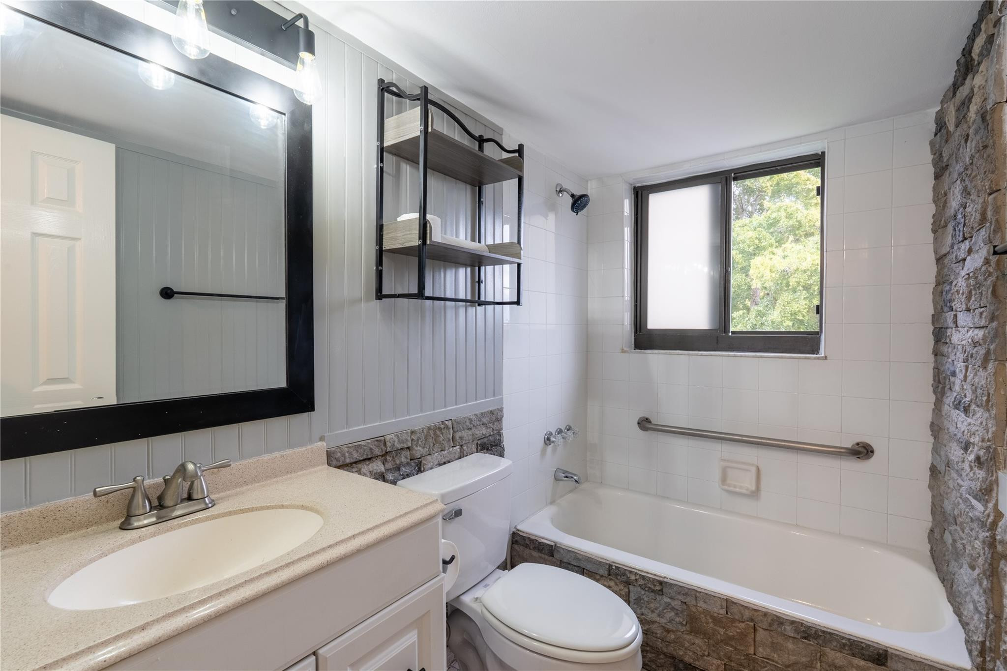 3720 North Pine Island Road, Unit 436 Sunrise, FL 33351 - Photo 17 of 26 a bathroom with a toilet a sink a mirror a bathtub and shower