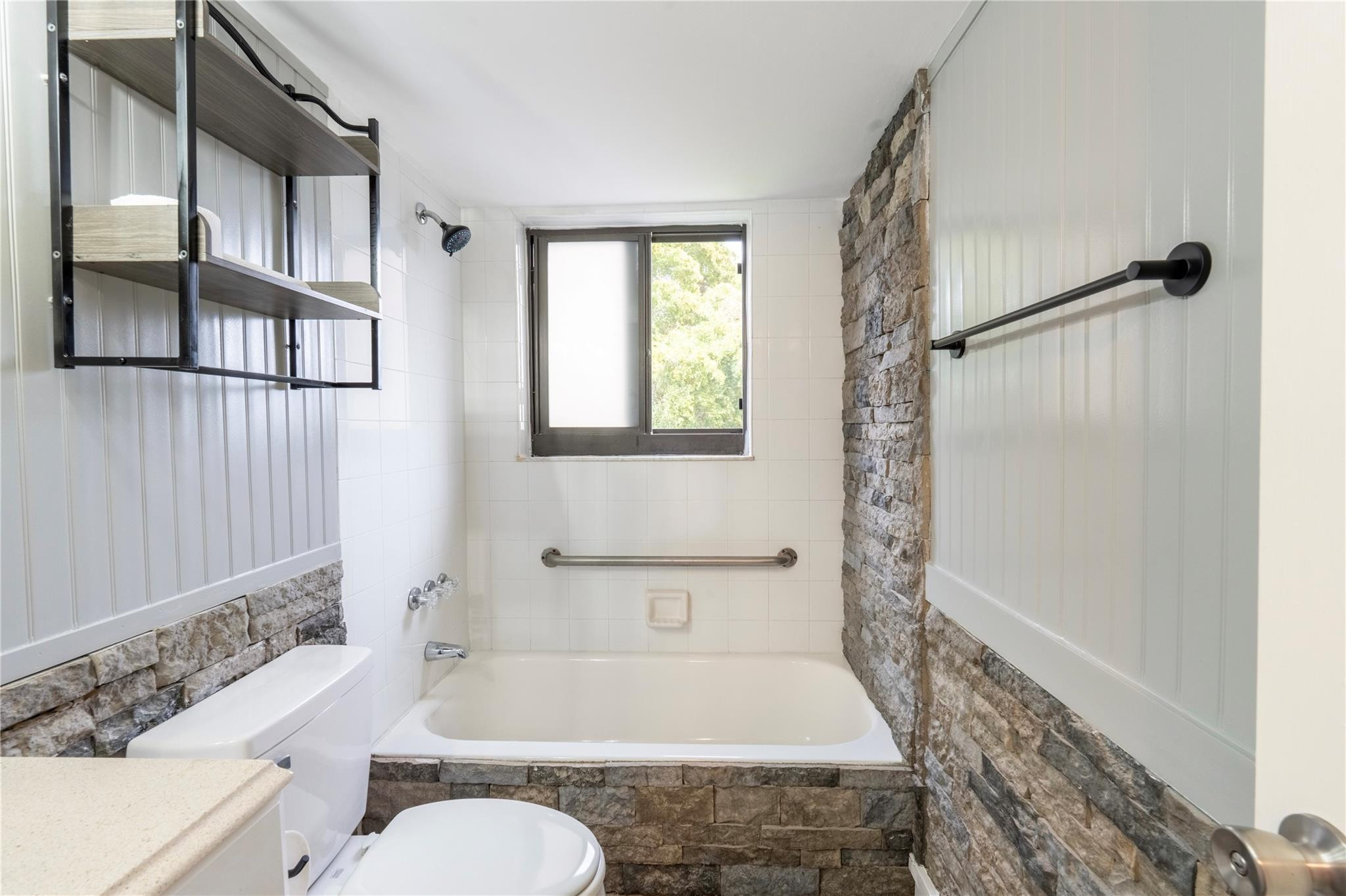 3720 North Pine Island Road, Unit 436 Sunrise, FL 33351 - Photo 19 of 26 a bathroom with a granite countertop bathtub shower sink vanity and toilet