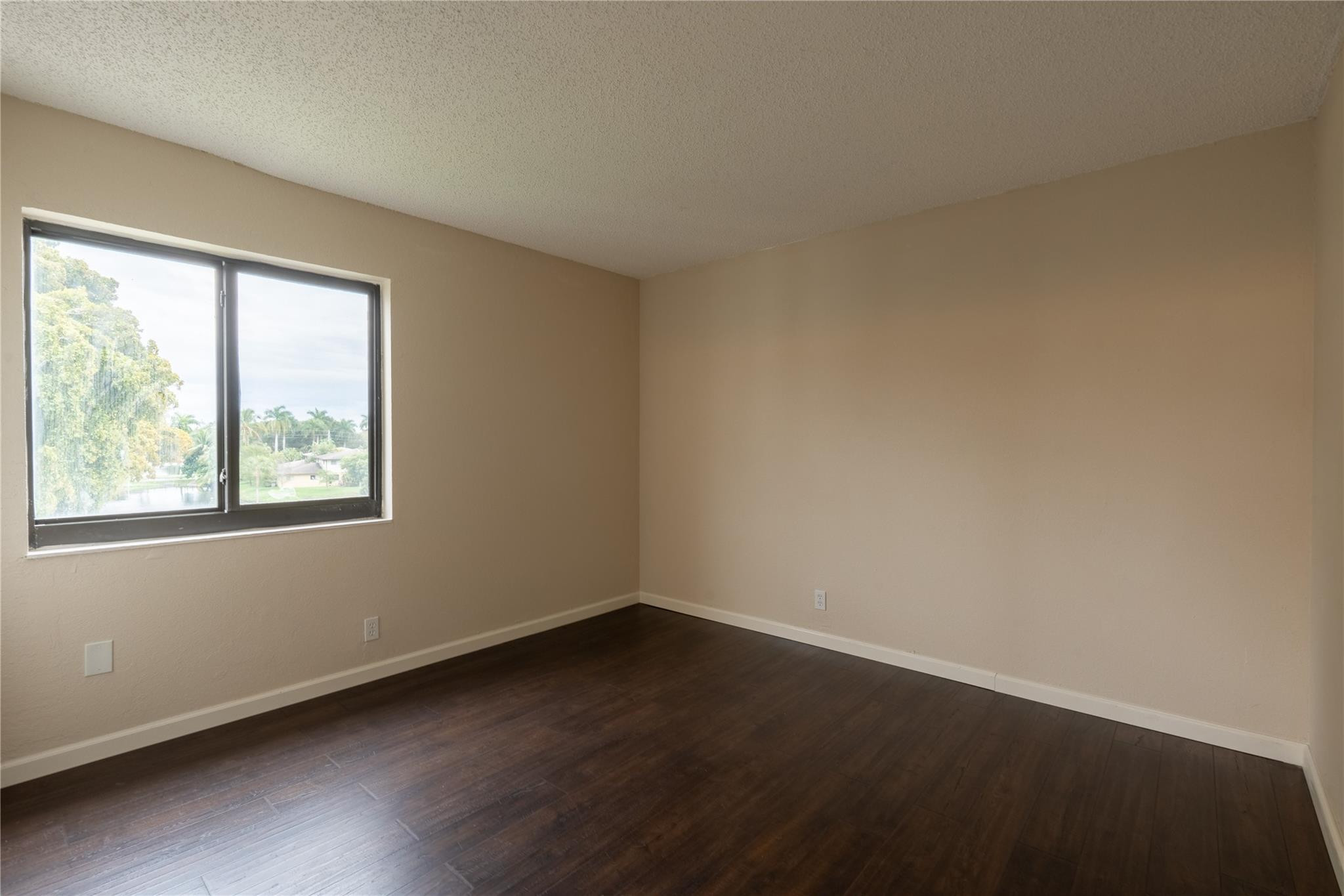 3720 North Pine Island Road, Unit 436 Sunrise, FL 33351 - Photo 20 of 26 an empty room with wooden floor and windows