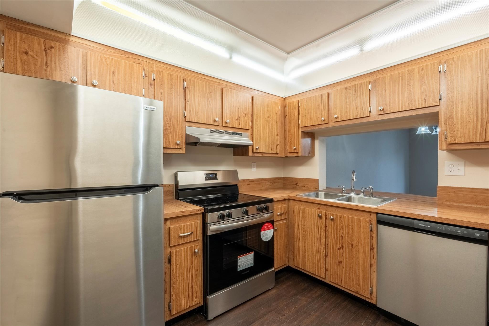 3720 North Pine Island Road, Unit 436 Sunrise, FL 33351 - Photo 5 of 26 a kitchen with a white cabinets and white appliances
