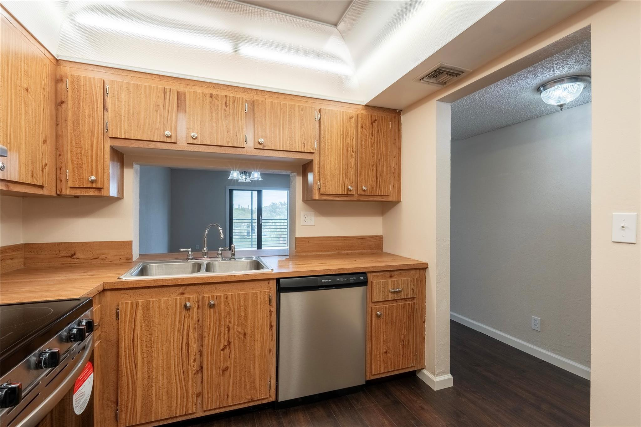 3720 North Pine Island Road, Unit 436 Sunrise, FL 33351 - Photo 7 of 26 a kitchen with a sink cabinets and wooden floor