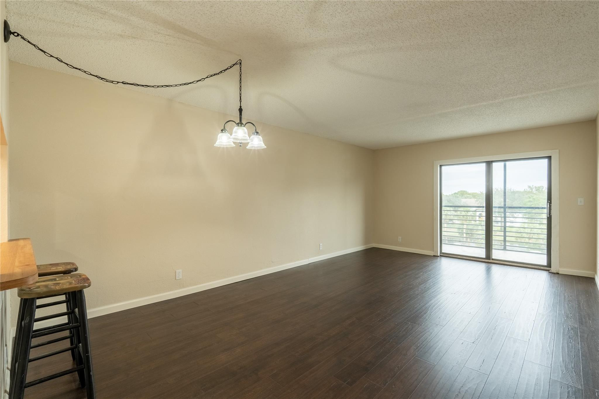 3720 North Pine Island Road, Unit 436 Sunrise, FL 33351 - Photo 8 of 26 a view of an empty room with wooden floor and a window