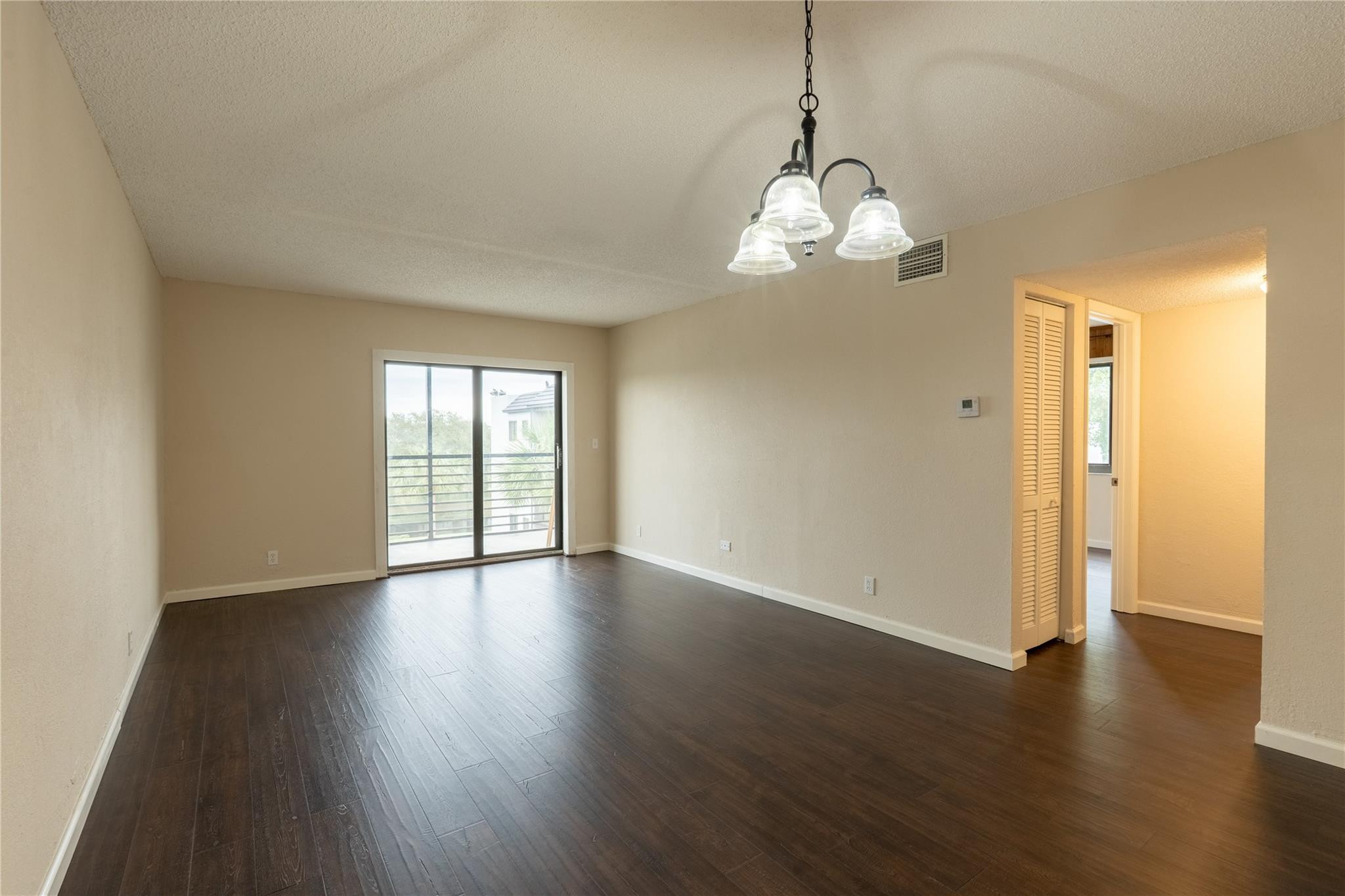3720 North Pine Island Road, Unit 436 Sunrise, FL 33351 - Photo 9 of 26 a view of a room with wooden floor chandelier and windows