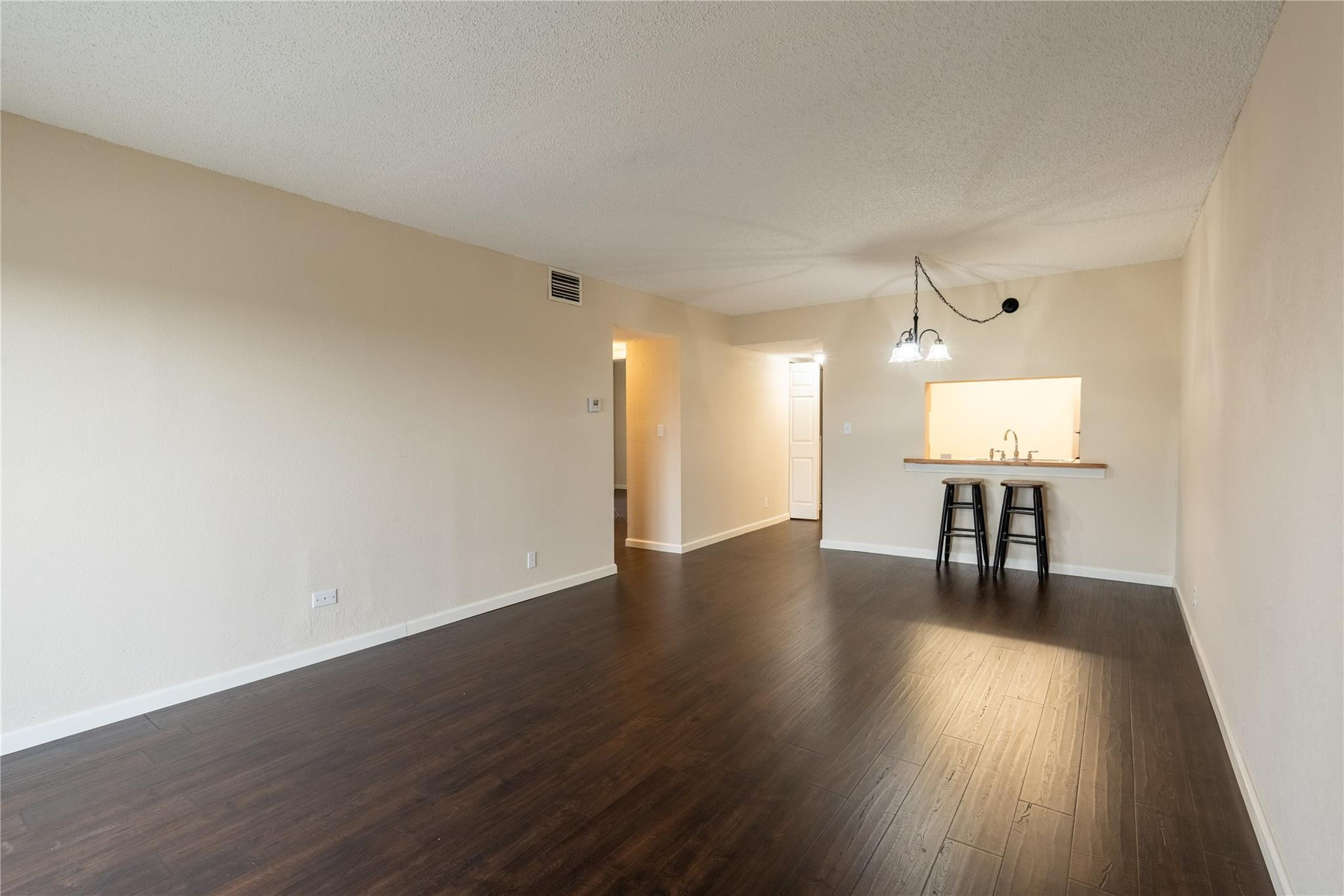 3720 North Pine Island Road, Unit 436 Sunrise, FL 33351 - Photo 10 of 26 a view of an empty room with wooden floor and a window