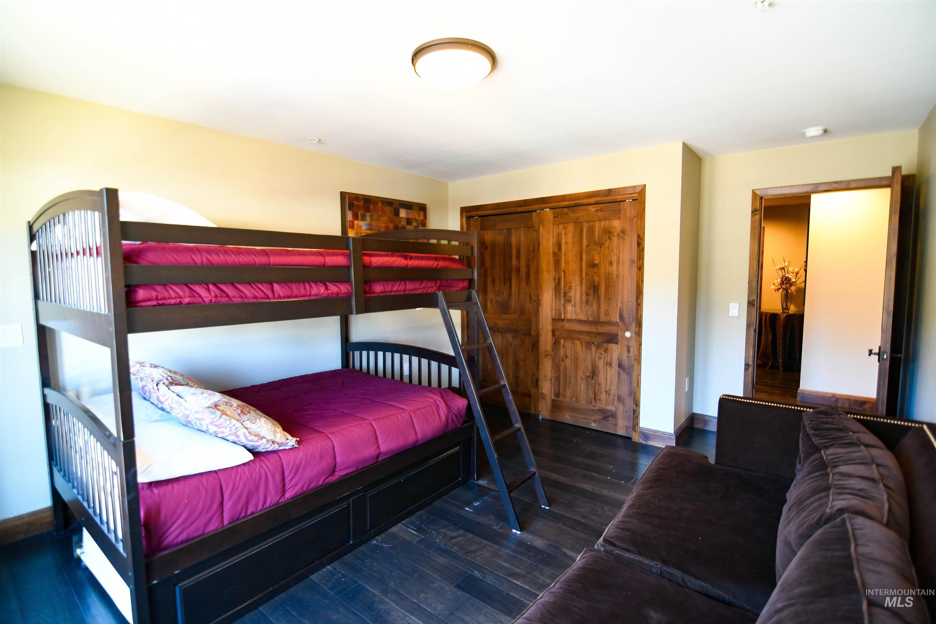 616 North 3rd Street, Unit 215 McCall, ID 83638 - Photo 24 of 36 Bedroom with dark wood finished floors and a closet