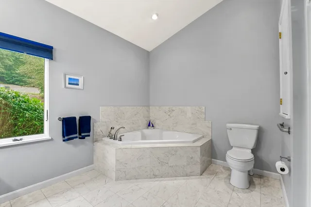 a bedroom with a bed dresser and a window