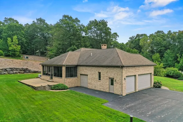 a aerial view of a house with a yard table and chairs