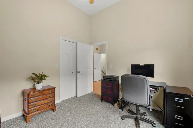 a bathroom with a granite countertop sink mirror vanity and toilet