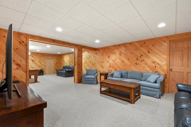 a view of a house with a big yard and large trees