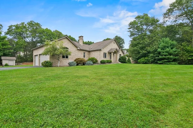 a green field with lots of trees in the background