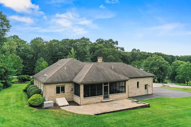 a view of a house with a yard and sitting area