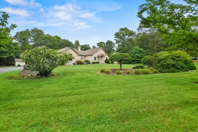 a front view of a house with a garden