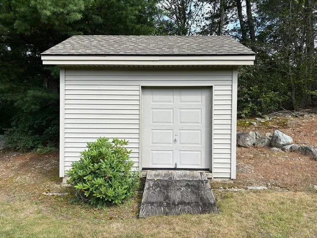 an aerial view of residential houses with outdoor space and trees