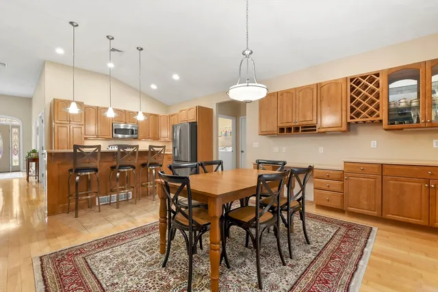 a living room with furniture kitchen view and a chandelier