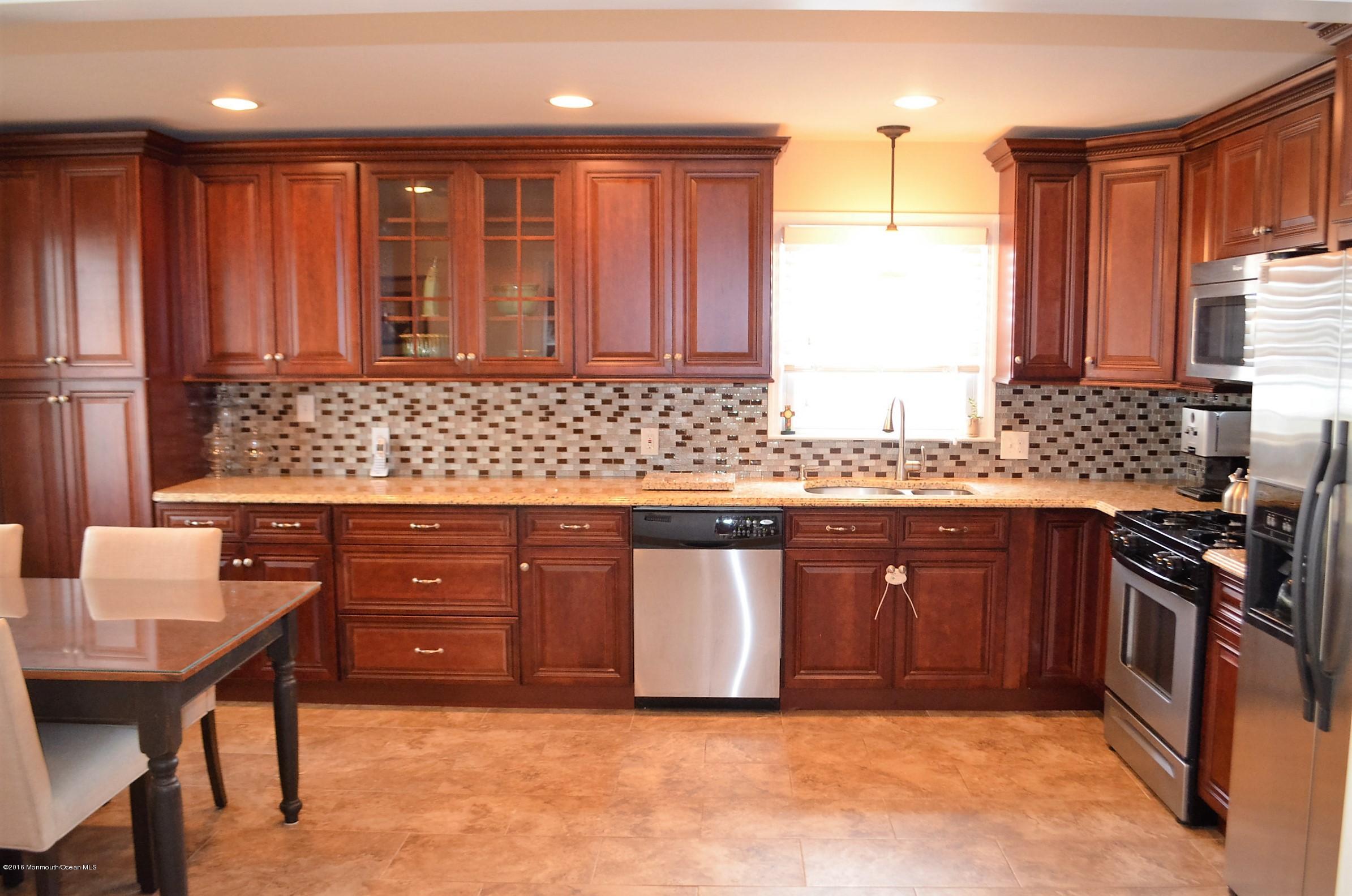 2216 Wilson Road Point Pleasant, NJ 08742 - Photo 3 of 20 a kitchen with stainless steel appliances granite countertop a sink stove and refrigerator