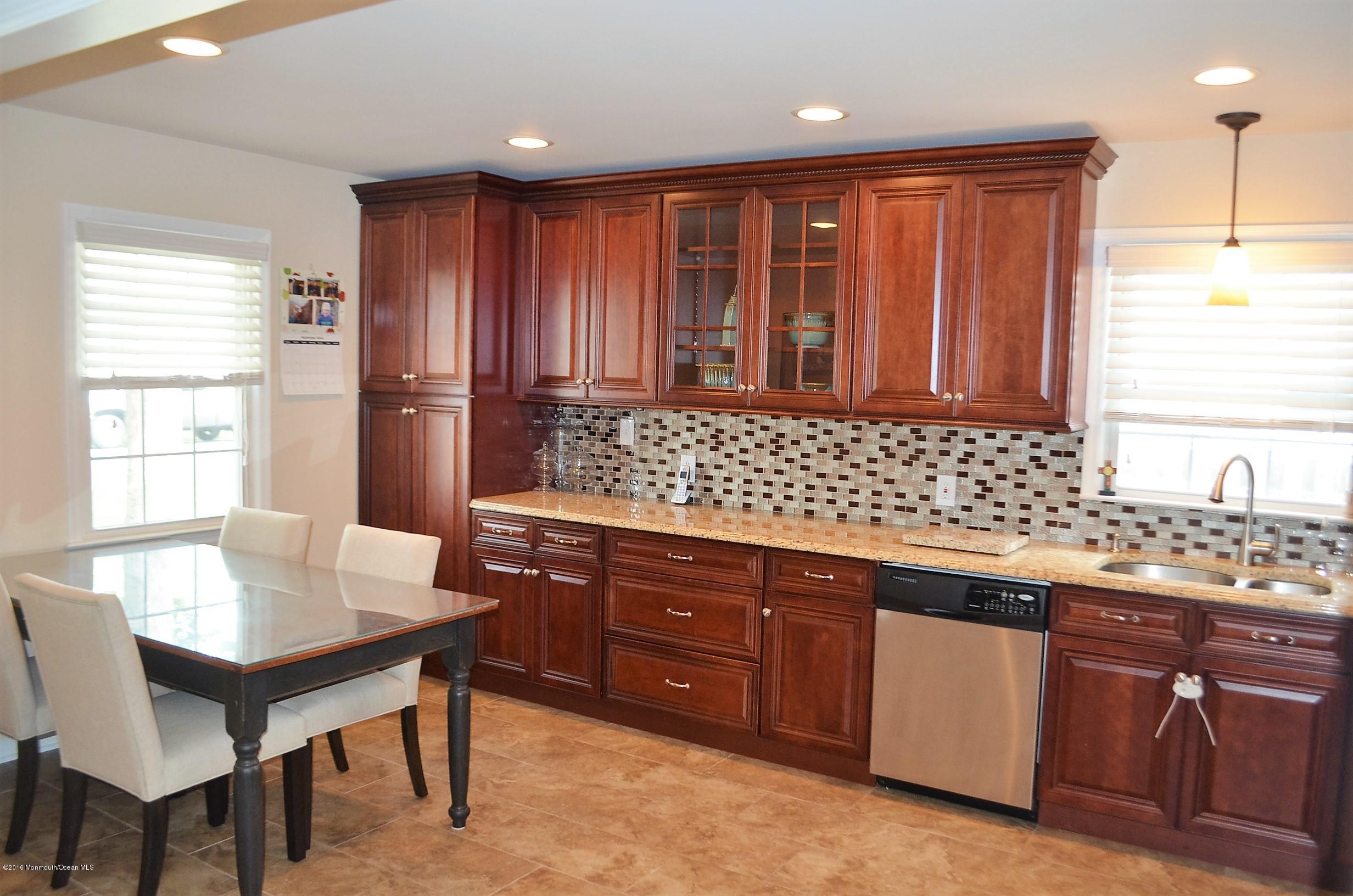 2216 Wilson Road Point Pleasant, NJ 08742 - Photo 4 of 20 a kitchen with stainless steel appliances granite countertop wooden cabinets a sink and a stove