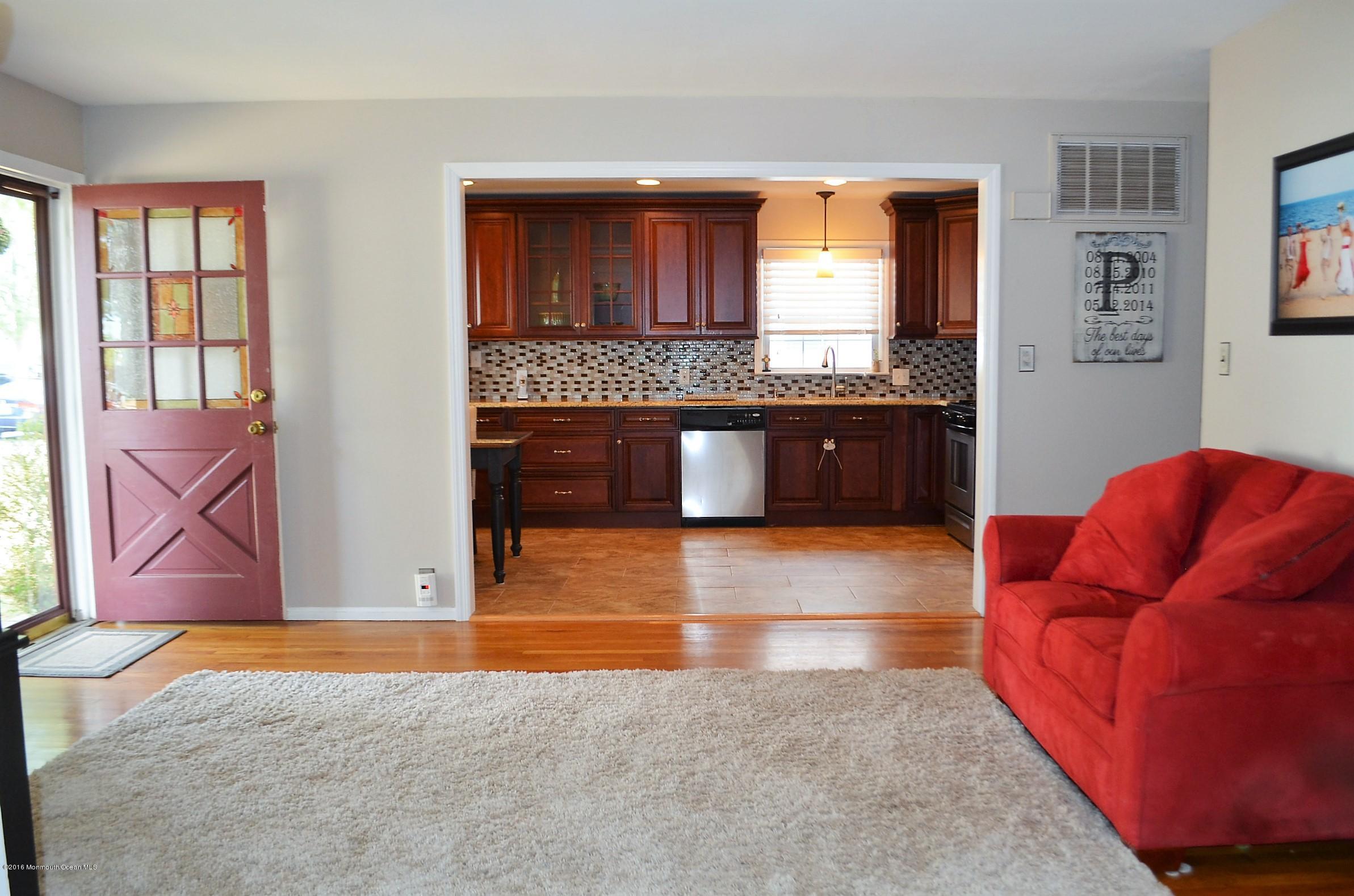 2216 Wilson Road Point Pleasant, NJ 08742 - Photo 6 of 20 a living room with stainless steel appliances granite countertop hardwood floor a fireplace and a large window