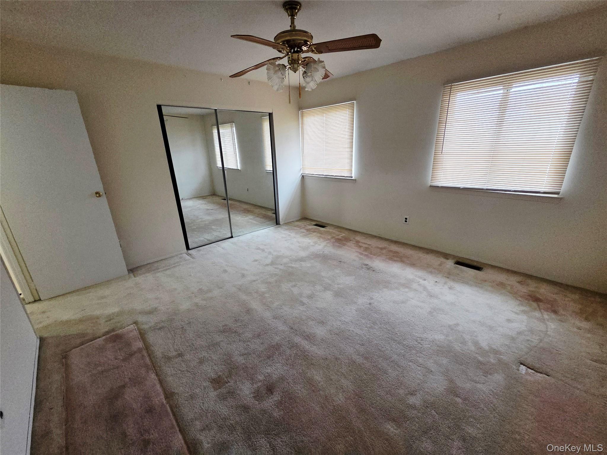 650 Newbridge Road, Unit 36 East Meadow, NY 11554 - Photo 11 of 14 a view of an empty room with a window