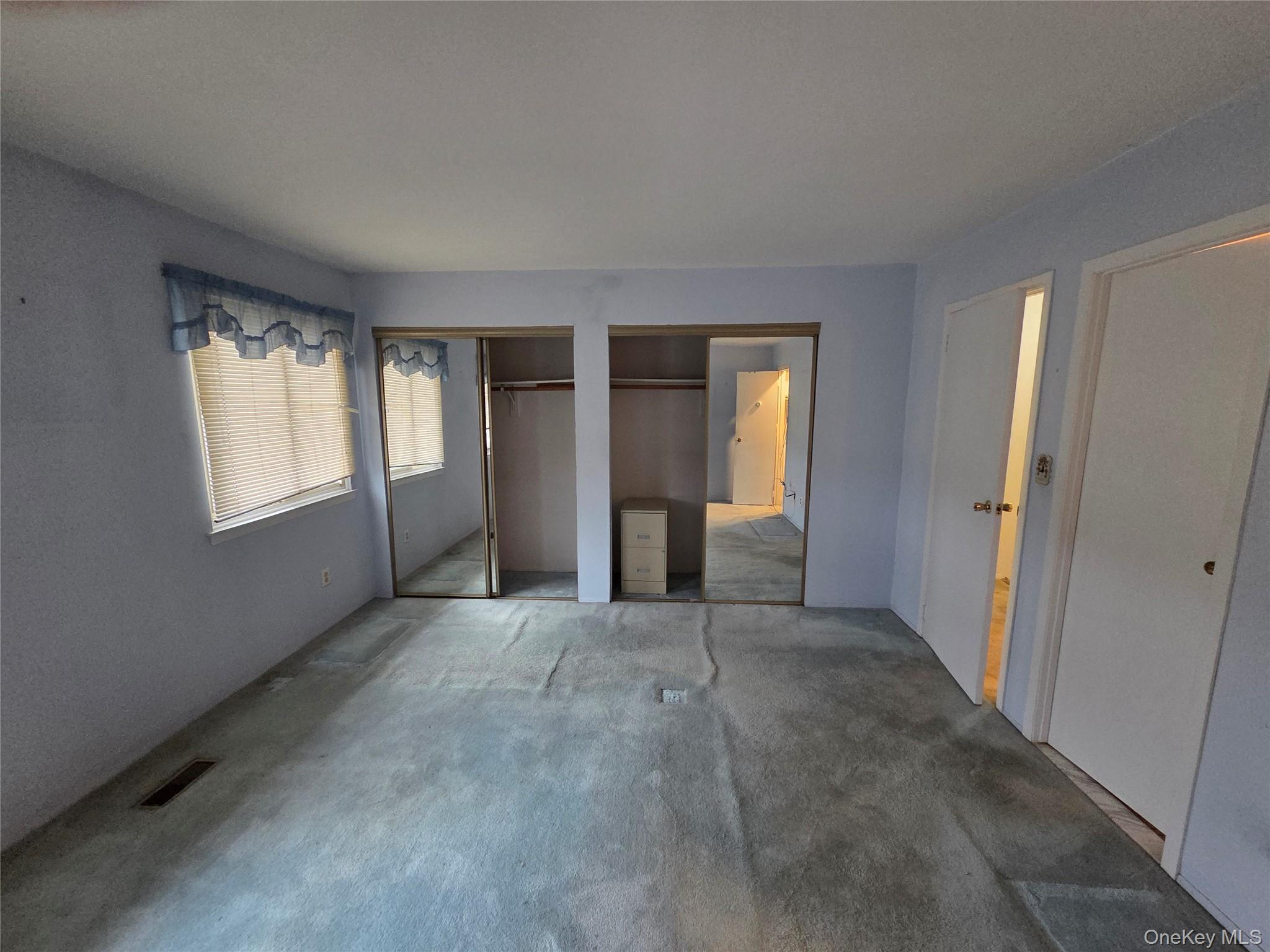 650 Newbridge Road, Unit 36 East Meadow, NY 11554 - Photo 12 of 14 an empty room with windows and closet