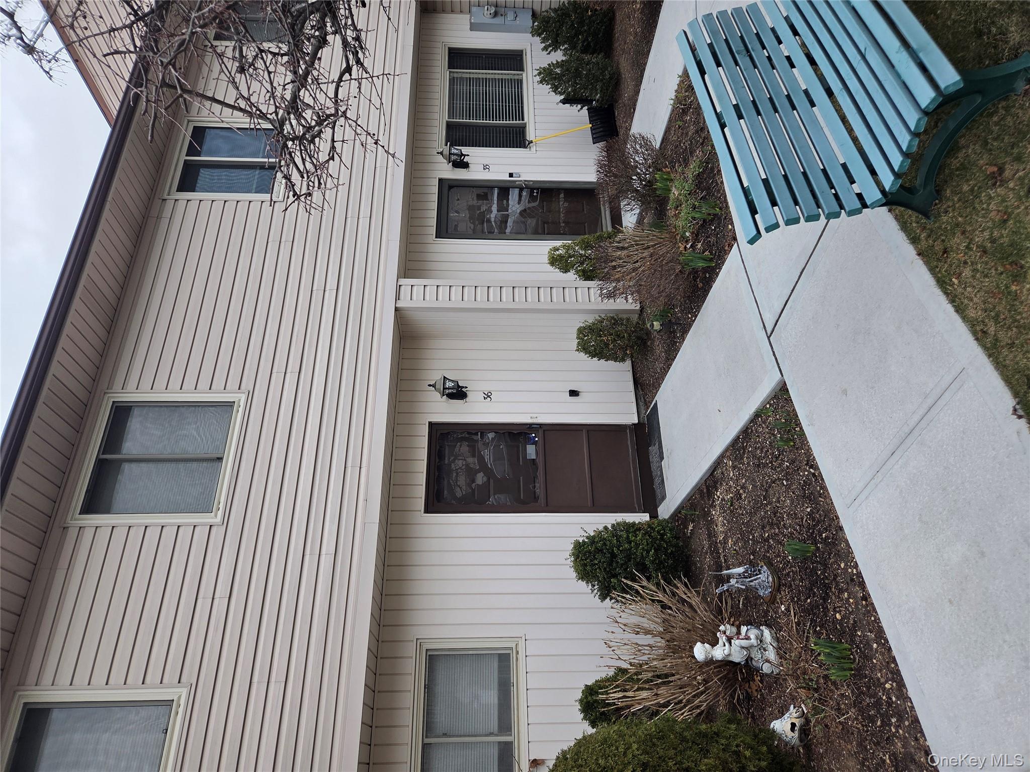 650 Newbridge Road, Unit 36 East Meadow, NY 11554 - Photo 14 of 14 a front view of a house with garden