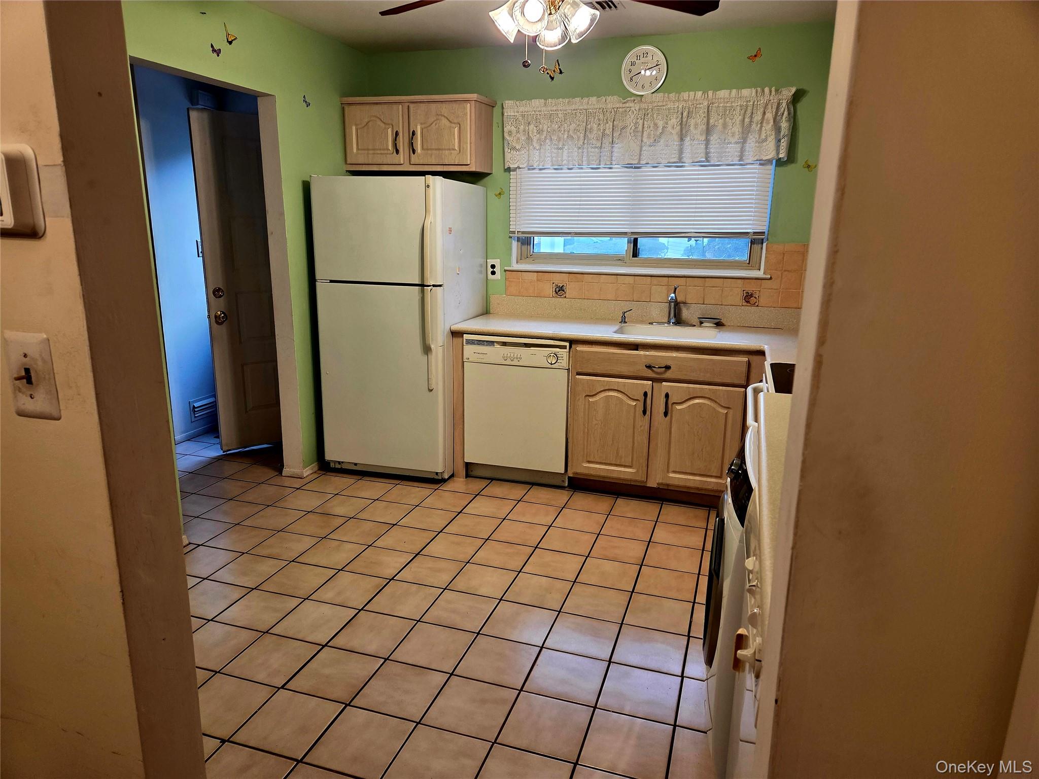 650 Newbridge Road, Unit 36 East Meadow, NY 11554 - Photo 4 of 14 a kitchen with a refrigerator sink and cabinets