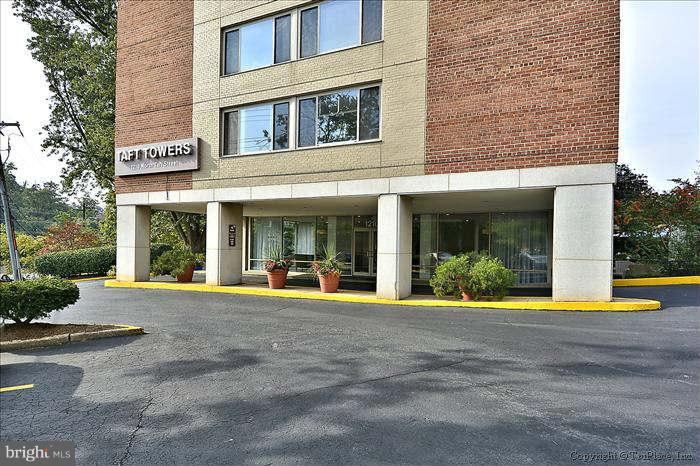 1210 North Taft Street, Unit 903 Arlington, VA 22201 - Photo 20 of 21 a front view of a building with a fountain and plants