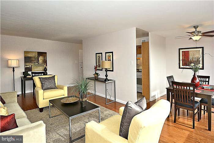 1210 North Taft Street, Unit 903 Arlington, VA 22201 - Photo 5 of 21 a living room with furniture a flat screen tv and a table