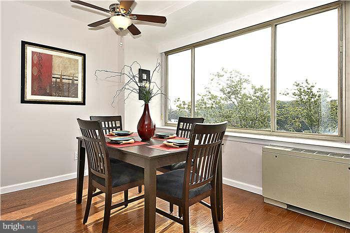 1210 North Taft Street, Unit 903 Arlington, VA 22201 - Photo 7 of 21 a dining room with furniture a large window and wooden floor