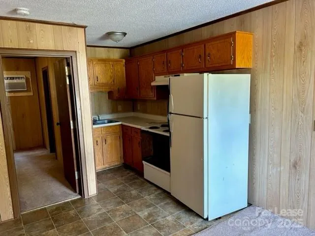 a view of a kitchen with a refrigerator