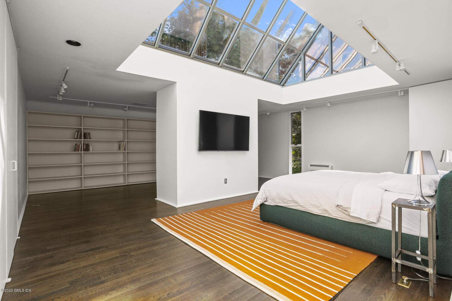 26 Chalburn Road Redding, CT 06896 - Photo 8 of 19 a bedroom with a bed and a flat tv screen on wall