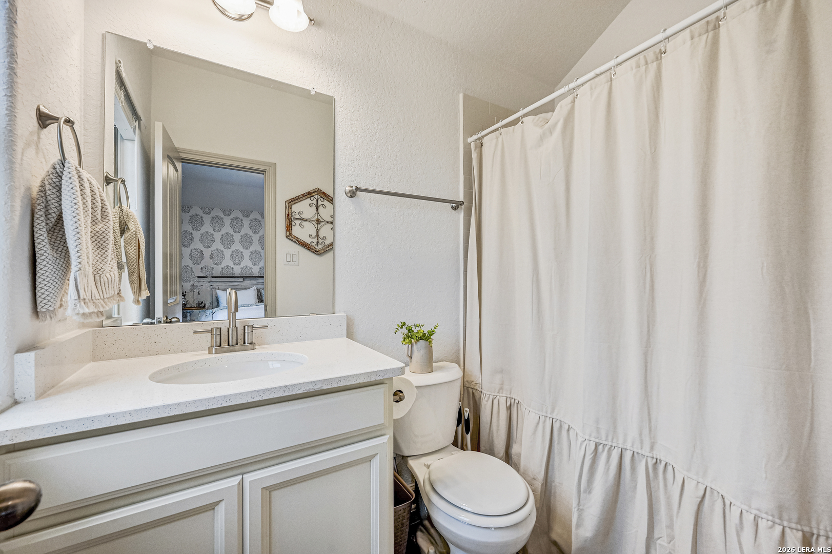 110 Breamoor Boerne, TX 78015 - Photo 30 of 38 a bathroom with a sink a toilet and a mirror