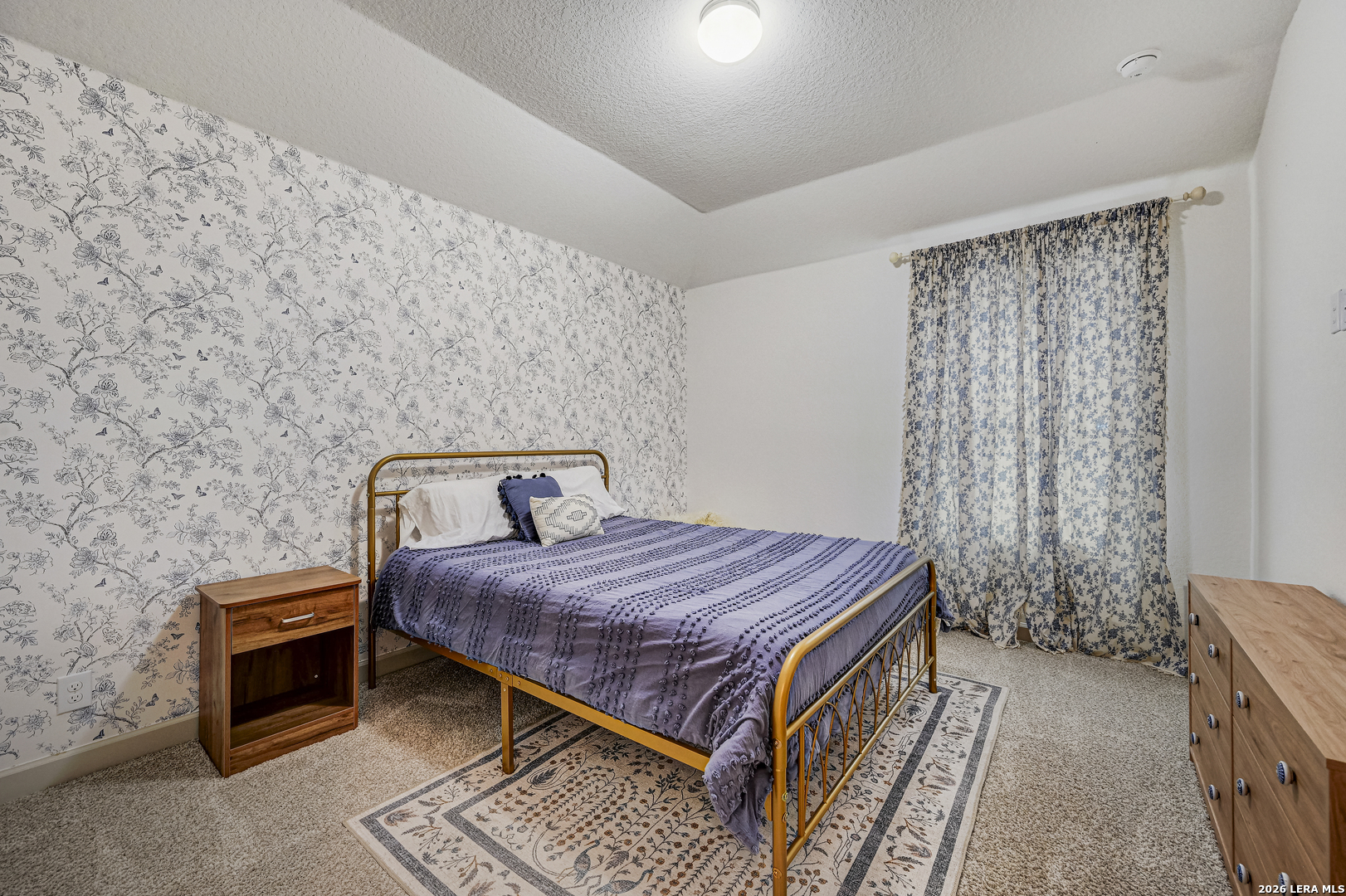 110 Breamoor Boerne, TX 78015 - Photo 32 of 38 a bed sitting in a bedroom next to a curtain