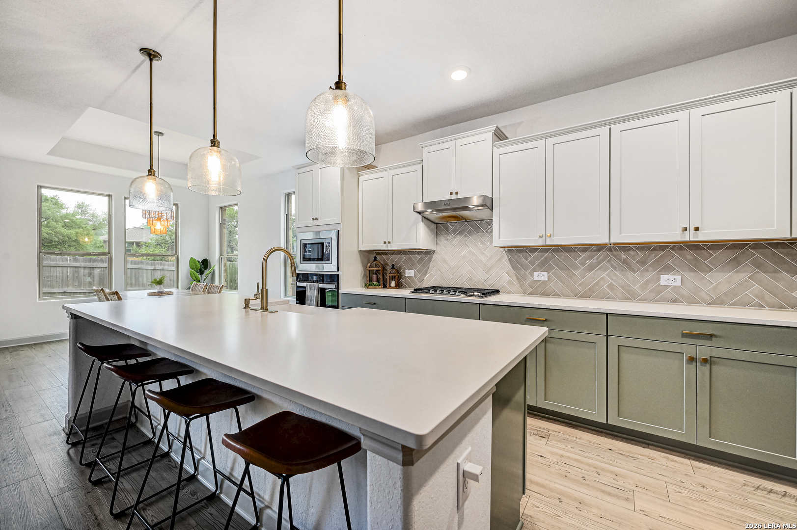 110 Breamoor Boerne, TX 78015 - Photo 7 of 38 a kitchen with a table a sink cabinets and wooden floor