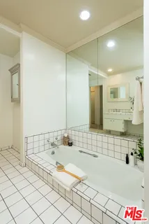 a spacious bedroom with a bed and a couch