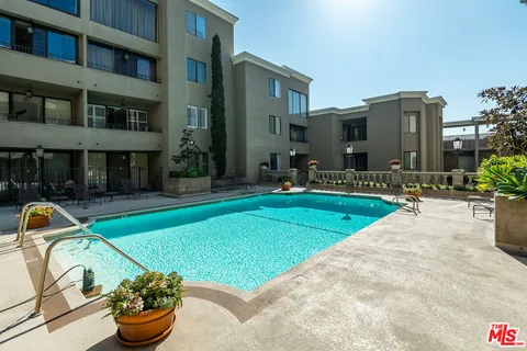 a view of a house with swimming pool and sitting area