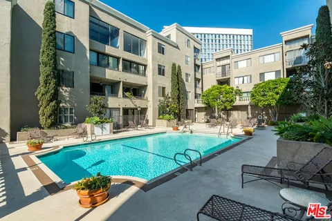 a view of a porch with a table and chairs