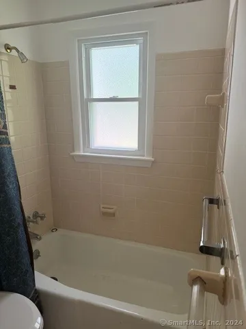 a white bath tub sitting next to a window