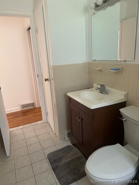 655 West Avenue, Unit BACK Milford, CT 06461 - Photo 12 of 18 a bathroom with a sink a toilet a mirror and shower