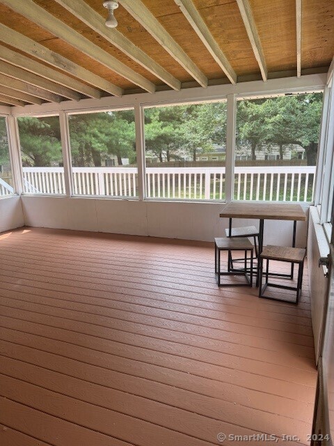 655 West Avenue, Unit BACK Milford, CT 06461 - Photo 14 of 18 a view of a chairs and table in patio with a wooden fence