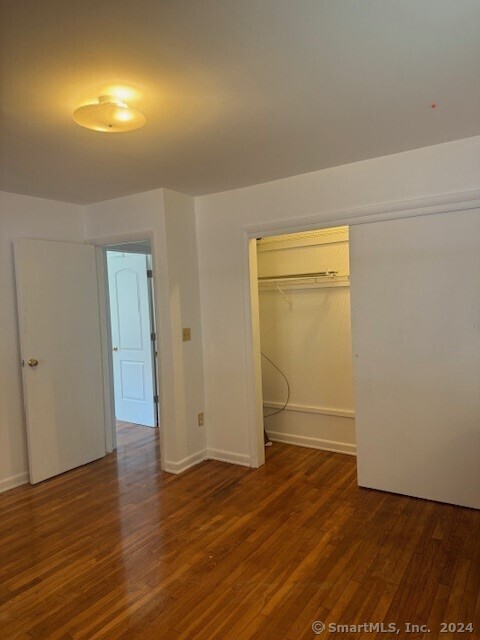 655 West Avenue, Unit BACK Milford, CT 06461 - Photo 7 of 18 an empty room with wooden floor and closet