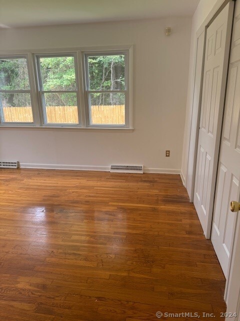 655 West Avenue, Unit BACK Milford, CT 06461 - Photo 8 of 18 a view of an empty room with wooden floor and a window