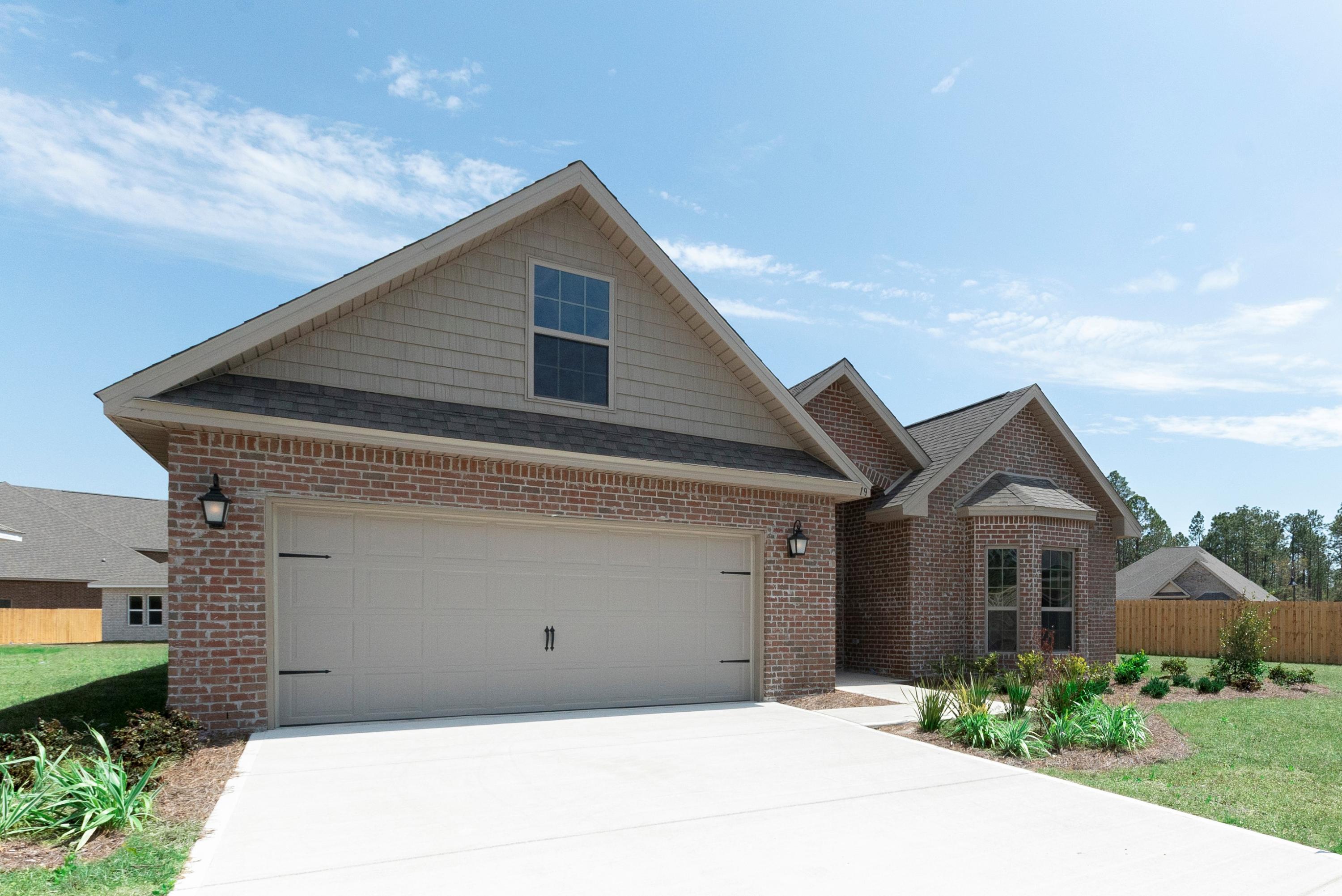 396 Wayne Trail Santa Rosa Beach, FL 32459 - Photo 1 of 30 a front view of a house with a garden