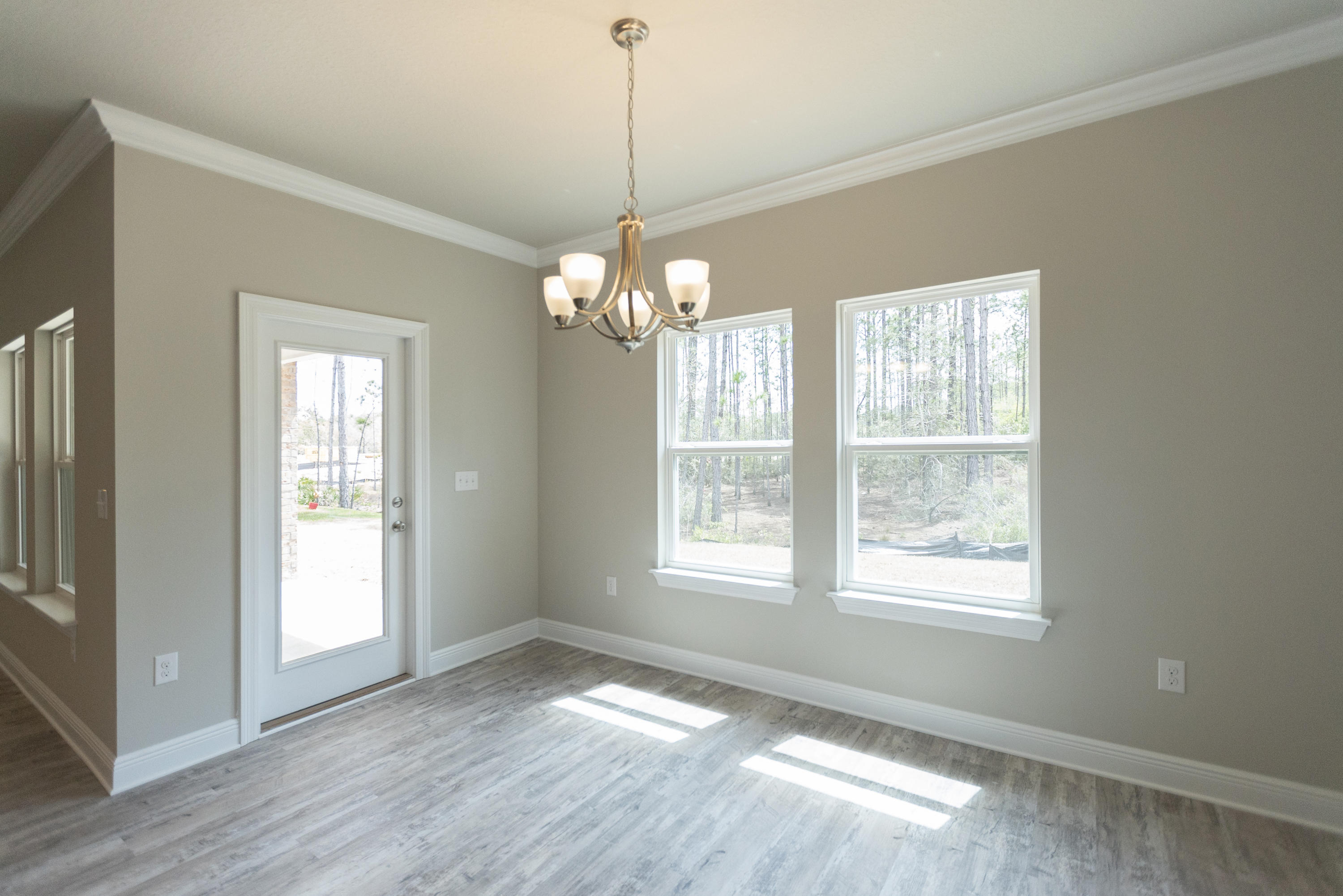 396 Wayne Trail Santa Rosa Beach, FL 32459 - Photo 11 of 30 a view of an empty room with wooden floor and a window
