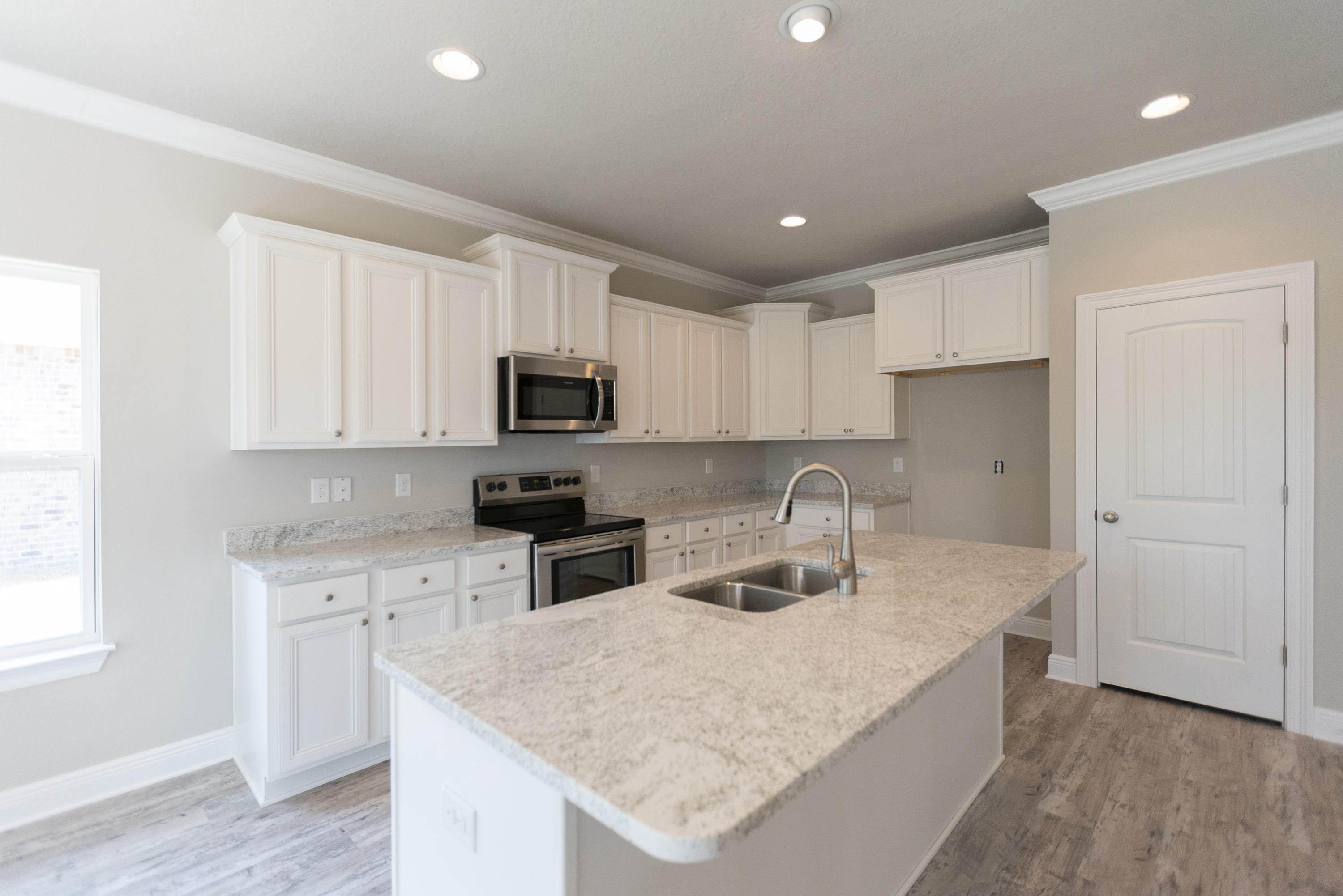 396 Wayne Trail Santa Rosa Beach, FL 32459 - Photo 10 of 30 a kitchen with granite countertop a sink a counter top space stainless steel appliances and cabinets