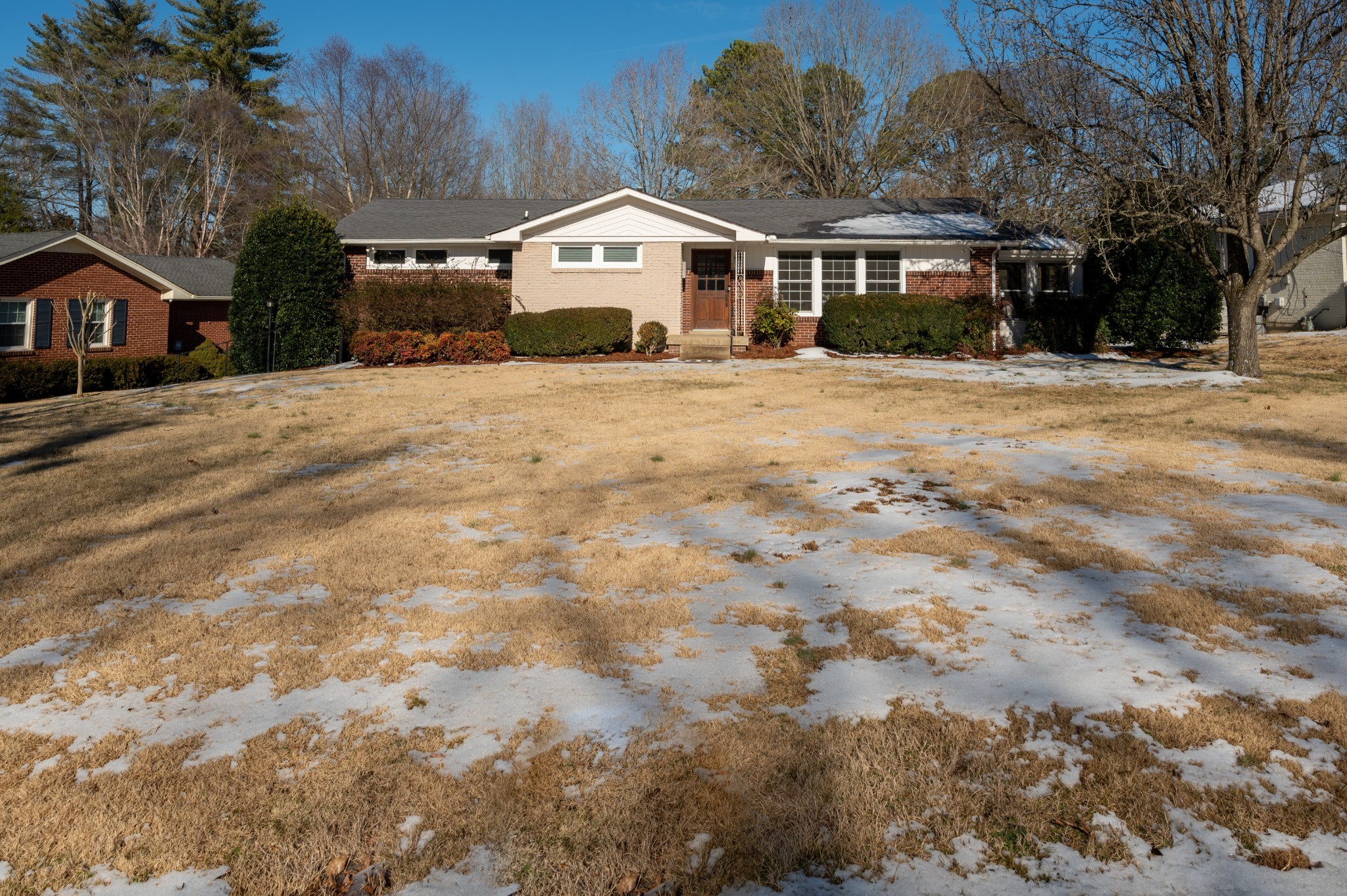 1208 Davidson Road Nashville, TN 37205 - Photo 2 of 30 a front view of a house with a yard covered with snow