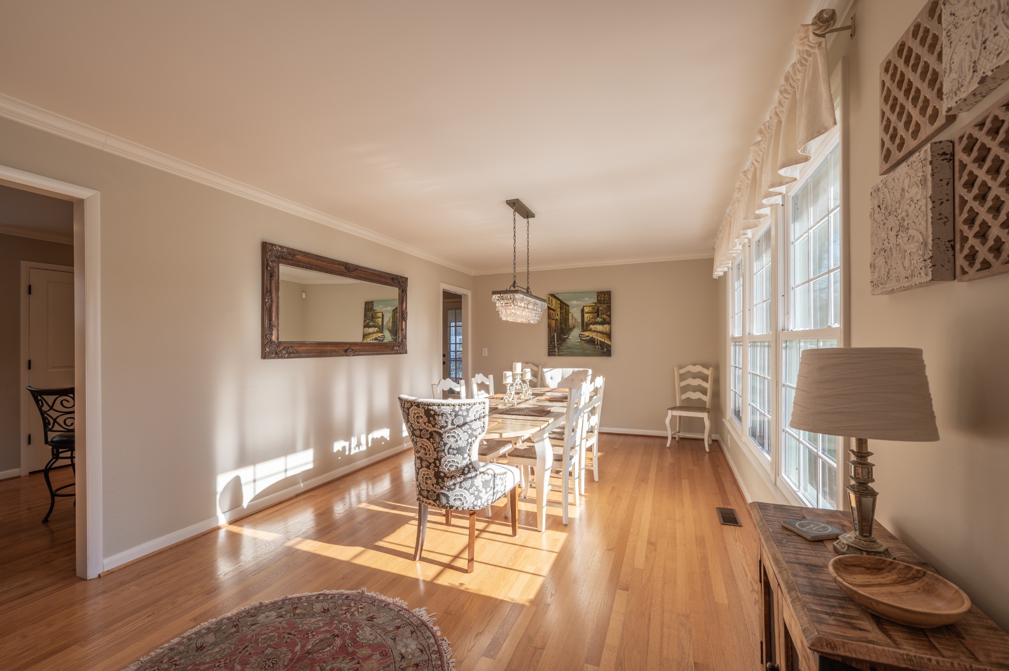 1208 Davidson Road Nashville, TN 37205 - Photo 5 of 30 a dining room with wooden floor a glass table and chairs