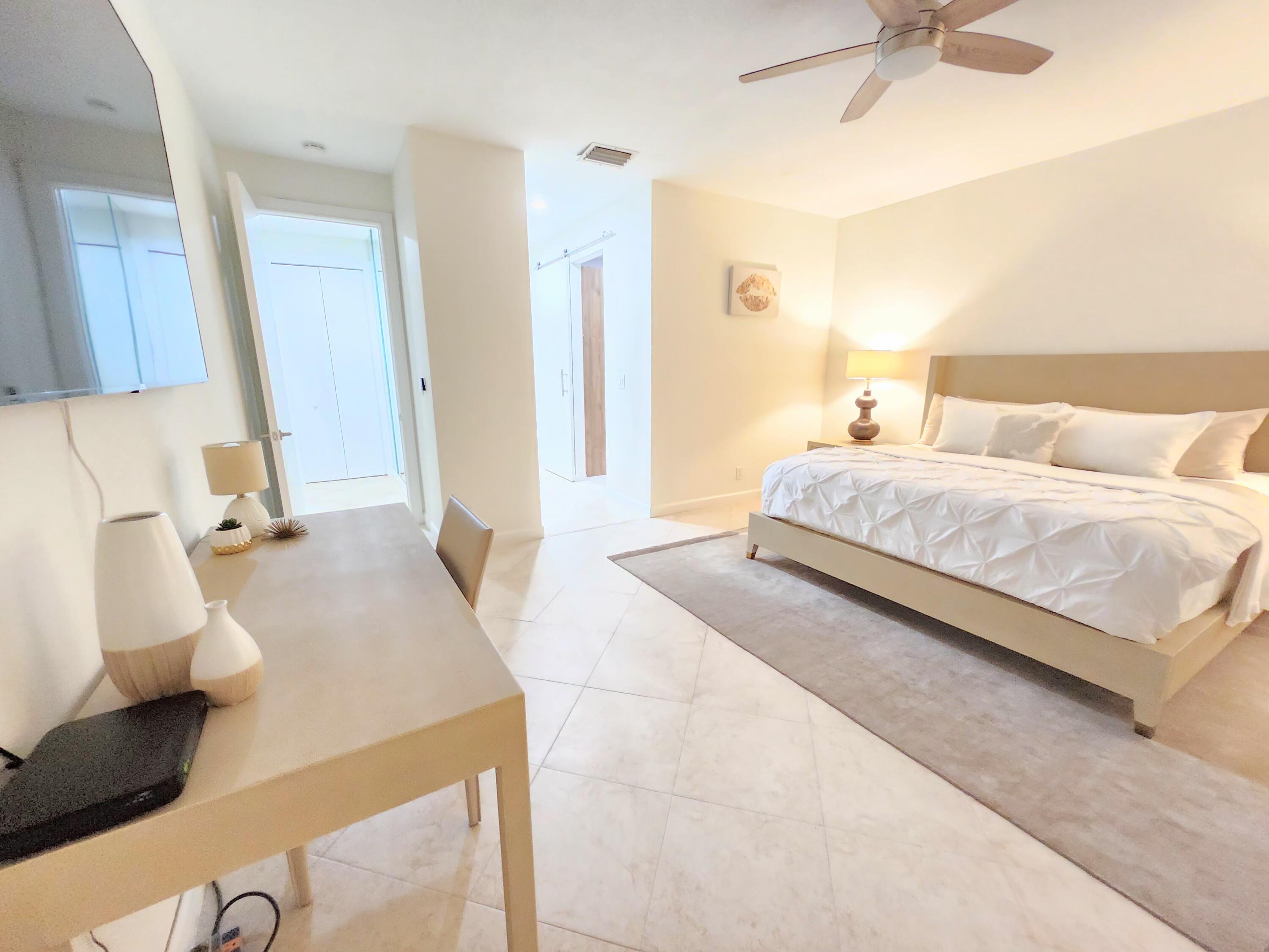 3567 Commodore Circle Delray Beach, FL 33483 - Photo 27 of 76 a bedroom with a bed and a couch