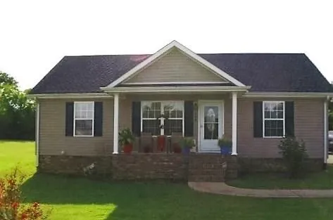 a front view of a house with garden