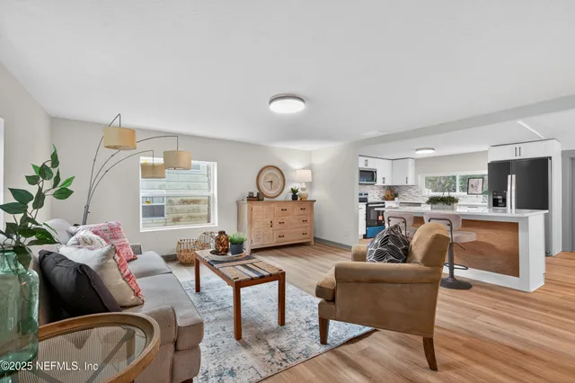 a view of a dining room with furniture and wooden floor